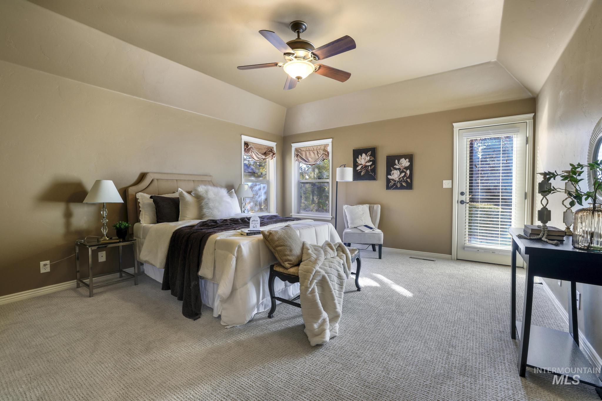 The Primary Bedroom suite has new carpet, ceiling fan, vaulted ceiling, arched walkways and outdoor access to the covered patio.