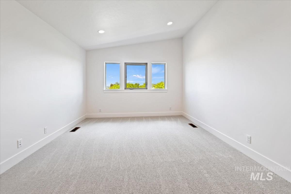 Room with light gray carpet, white walls, and a trio of windows
