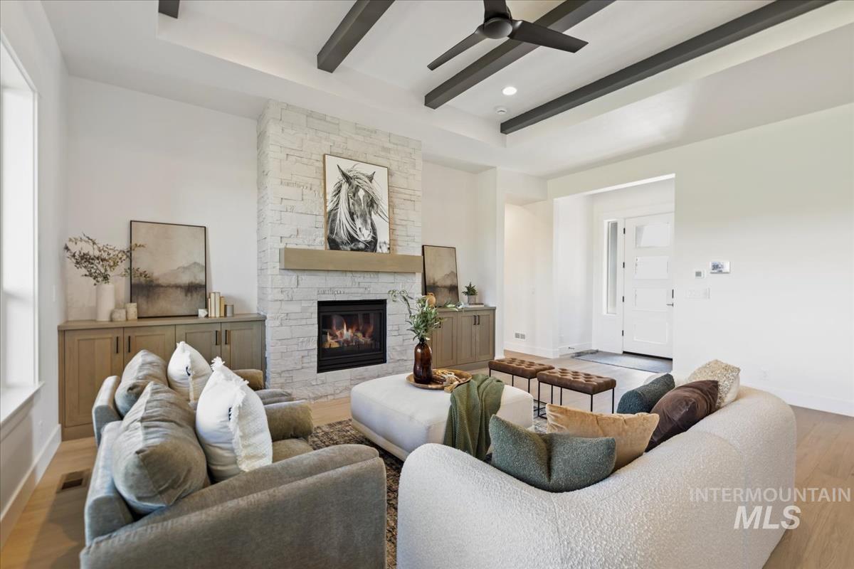 Living area with a stone-clad fireplace and wood mantle