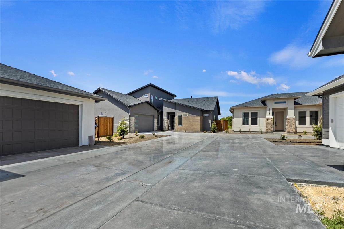 Expansive concrete driveway servicing multiple contemporary residences