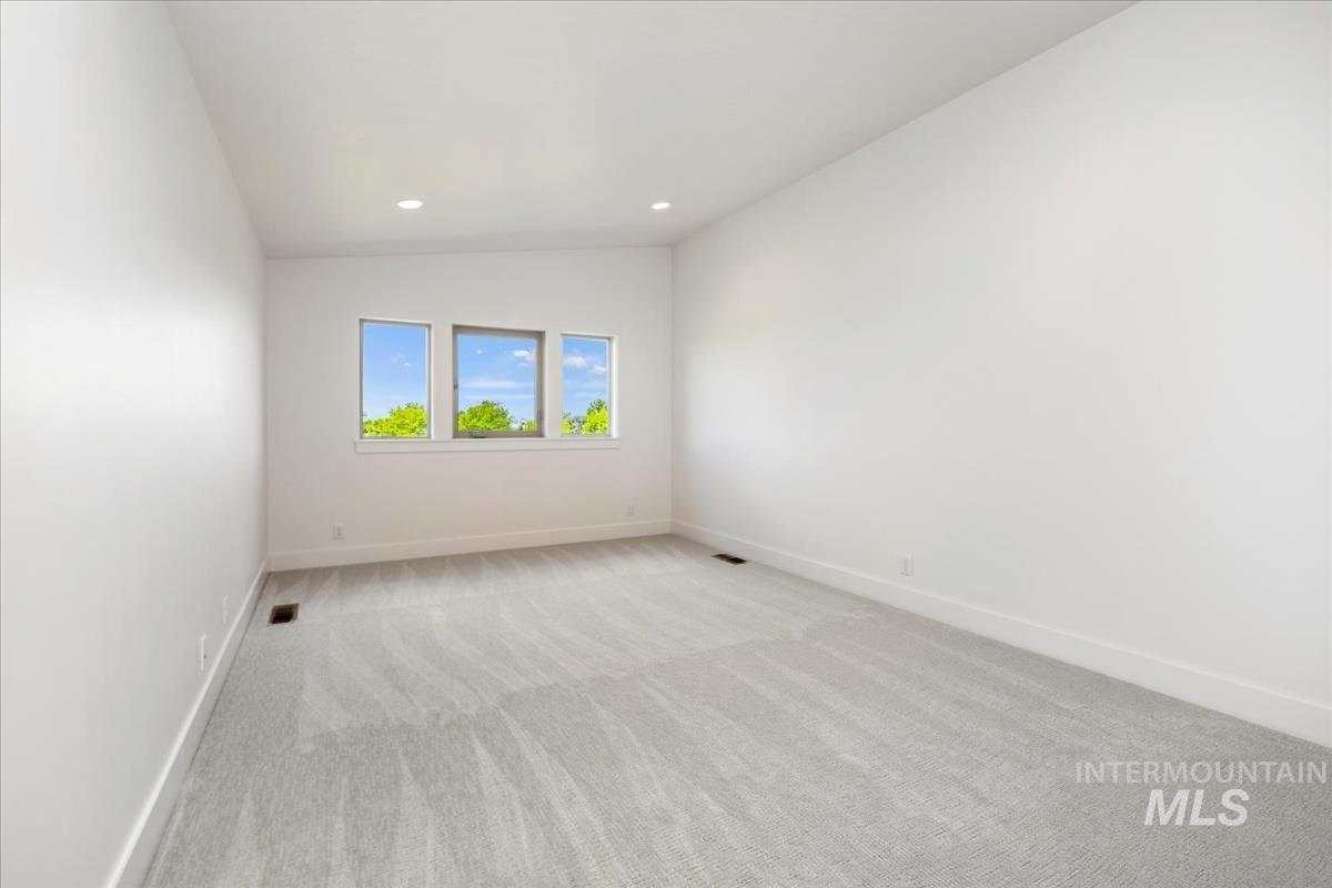 Neutral tone carpeting extending to the baseboards