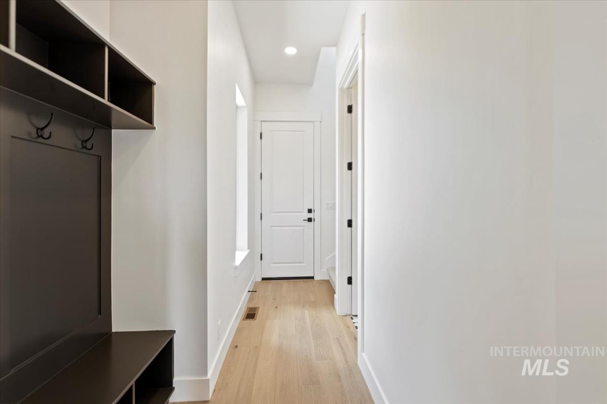 Built-in mudroom storage featuring coat hooks and shelving