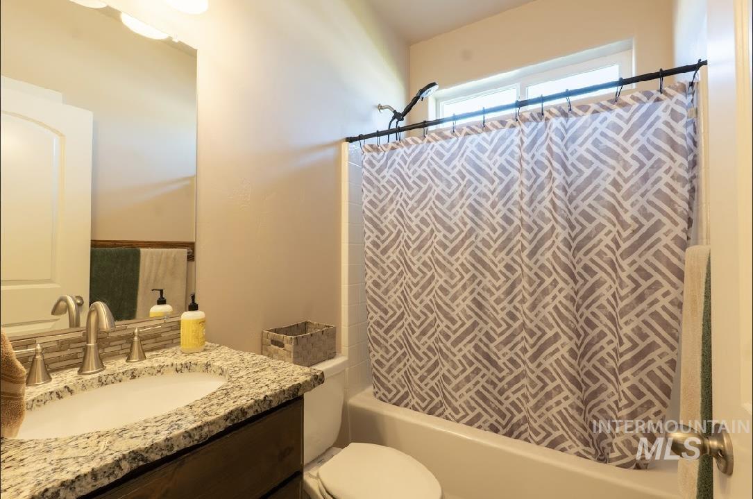 Bathroom featuring shower / bath combo and vanity