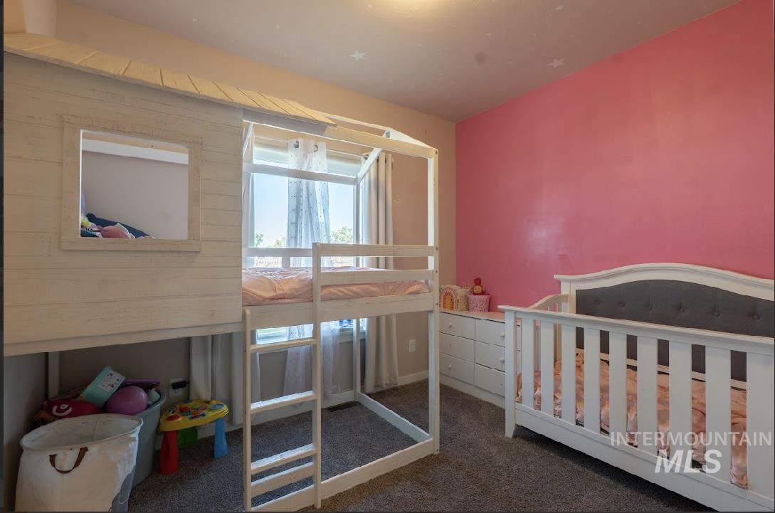 Bedroom with dark colored carpet