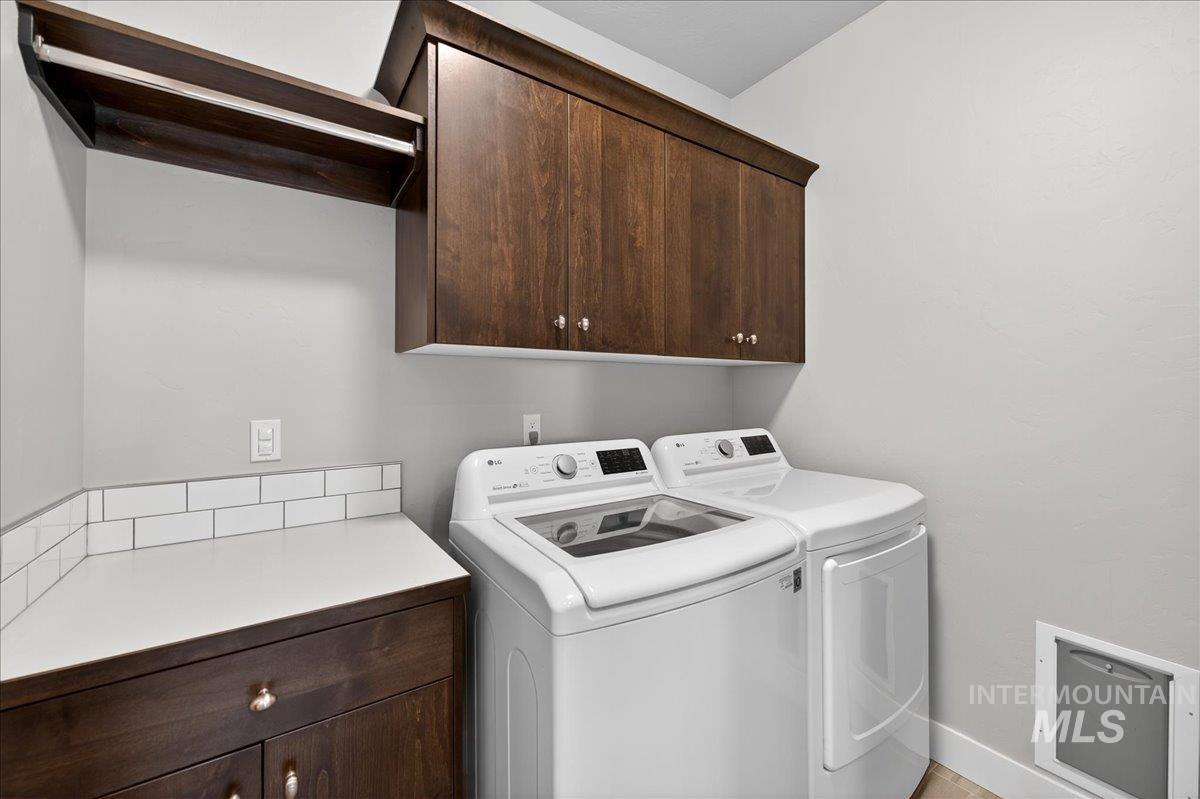 Laundry area featuring cabinet space and washer and dryer