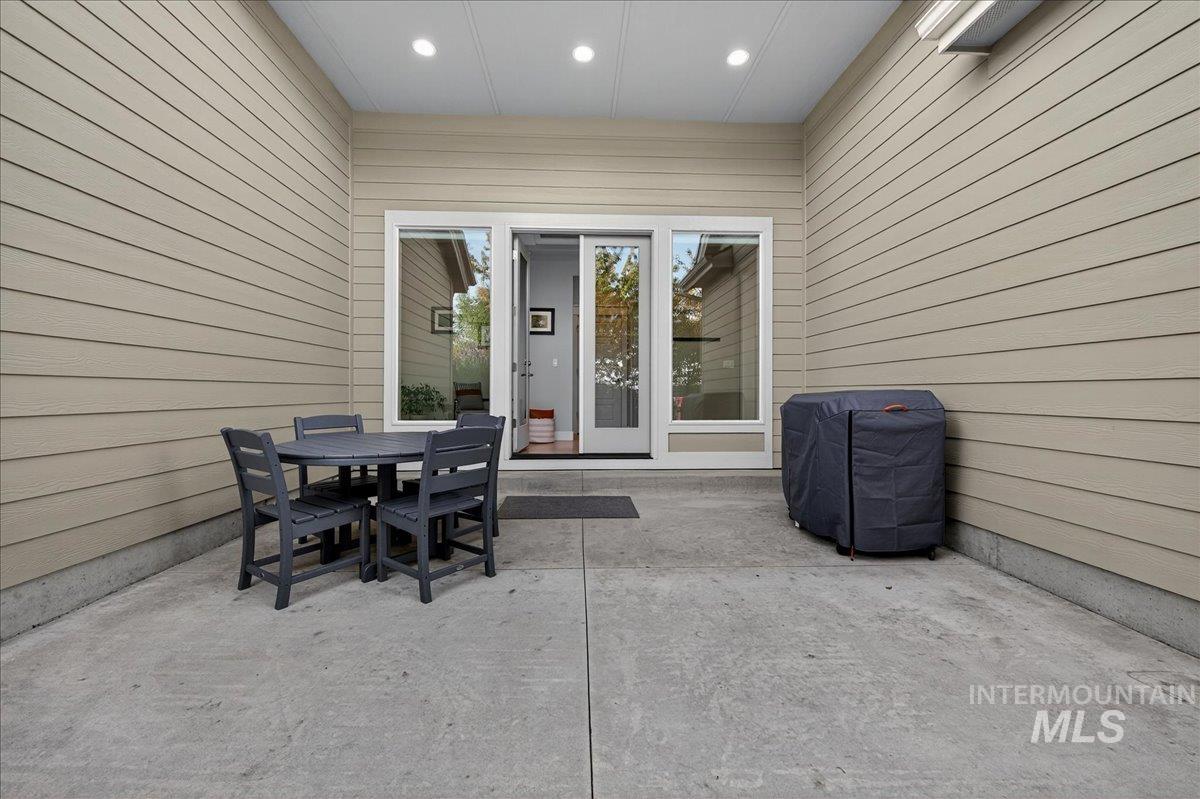 View of patio featuring grilling area and outdoor dining area