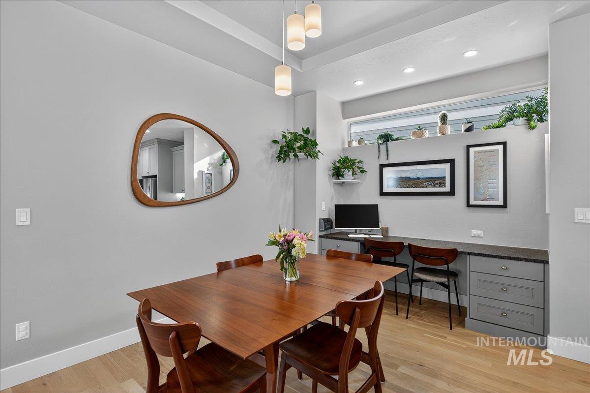 Dining area featuring light wood-type flooring, recessed lighting, and built in study area