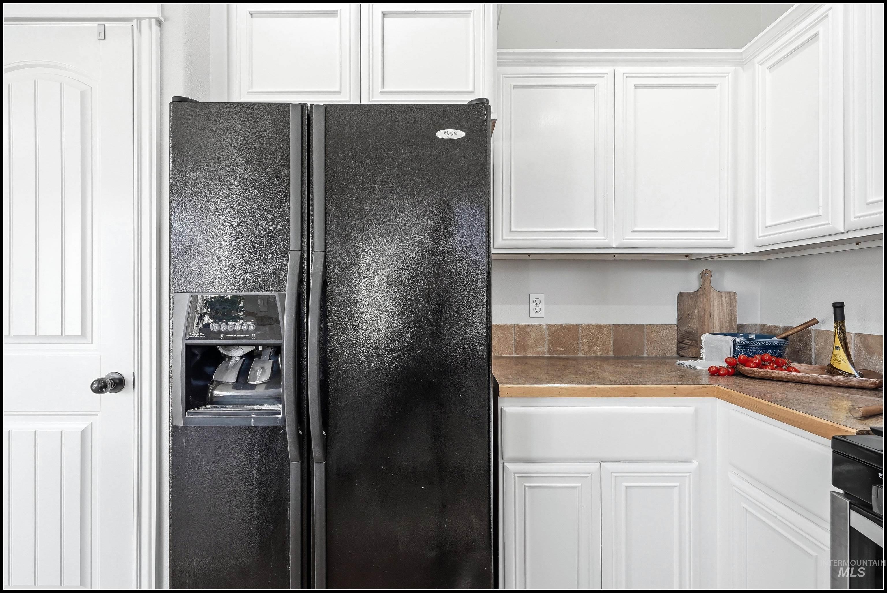 Black side-by-side refrigerator with an external ice and water dispenser included