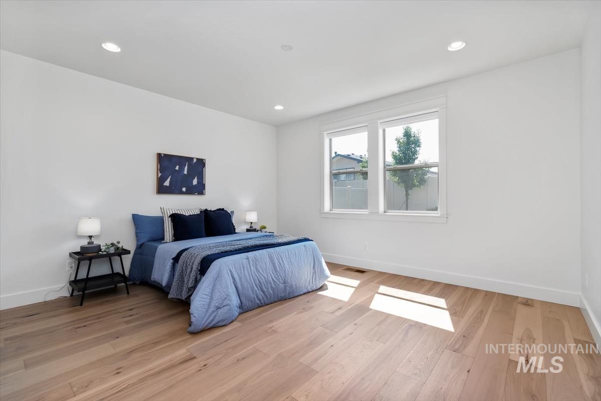 Bedroom with light wood-style flooring and recessed lighting