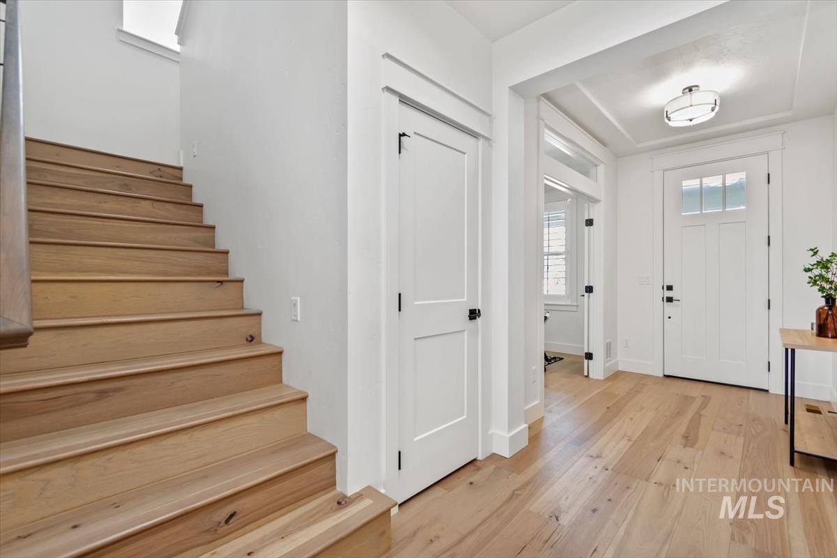 Entryway with light wood-style flooring and stairs