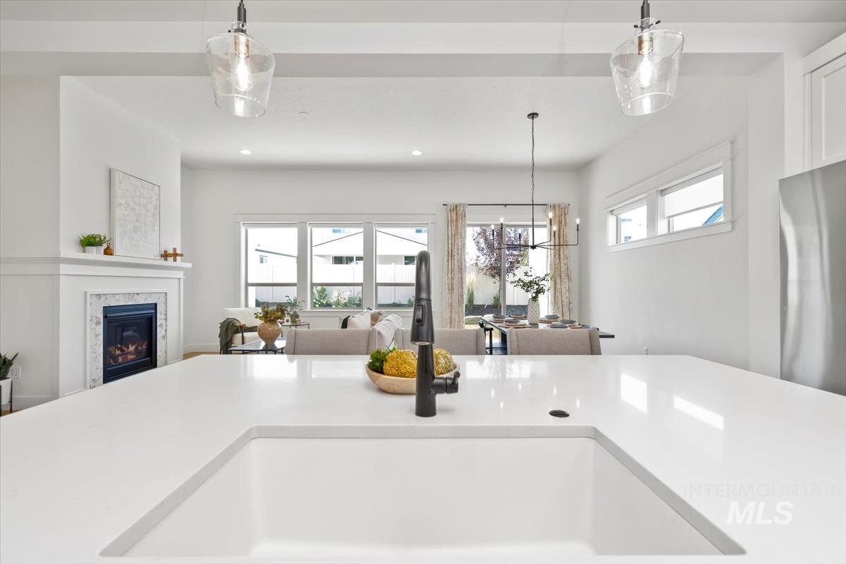 Kitchen featuring open floor plan, plenty of natural light, light countertops, and recessed lighting