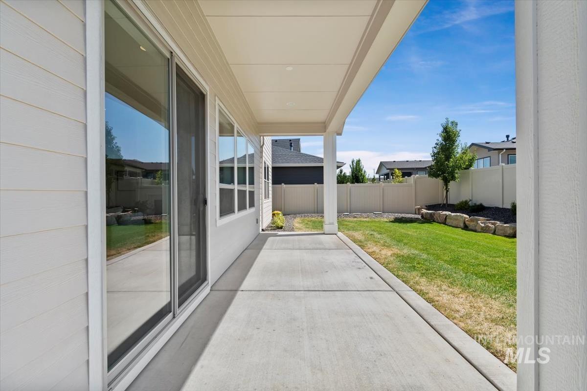Fenced backyard featuring a patio