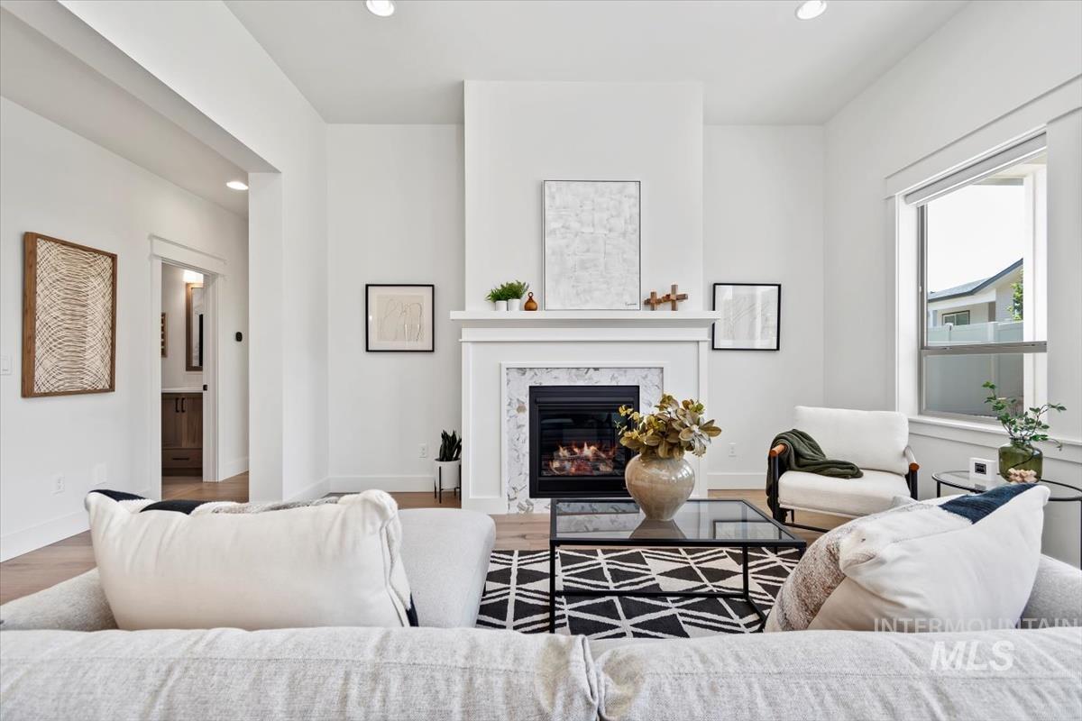 Living area featuring recessed lighting, a fireplace, and wood finished floors