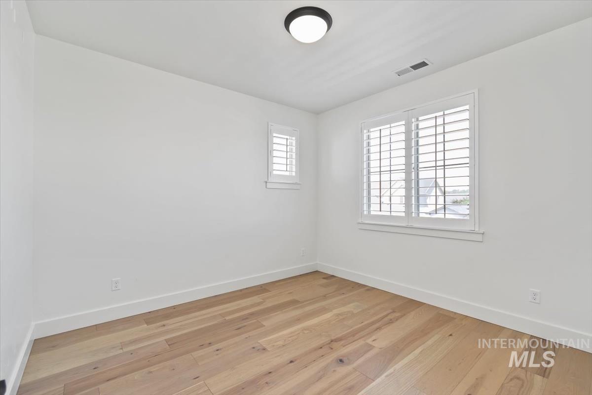 Unfurnished room with baseboards and wood finished floors
