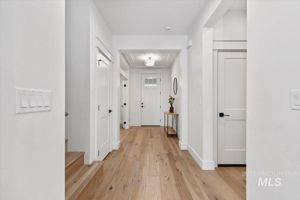 Hall with light wood-style flooring and baseboards