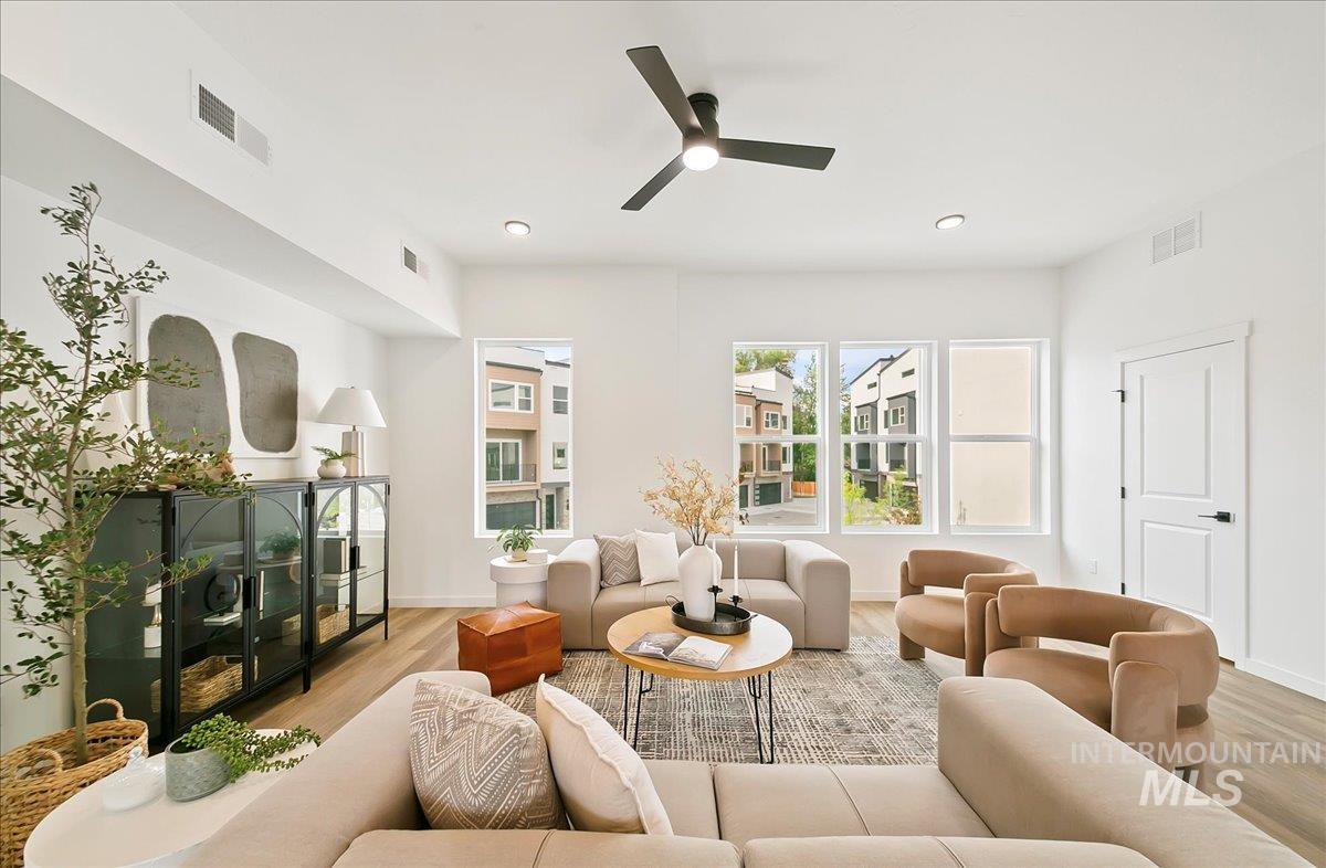 Living area featuring a ceiling fan and wood finished floors
