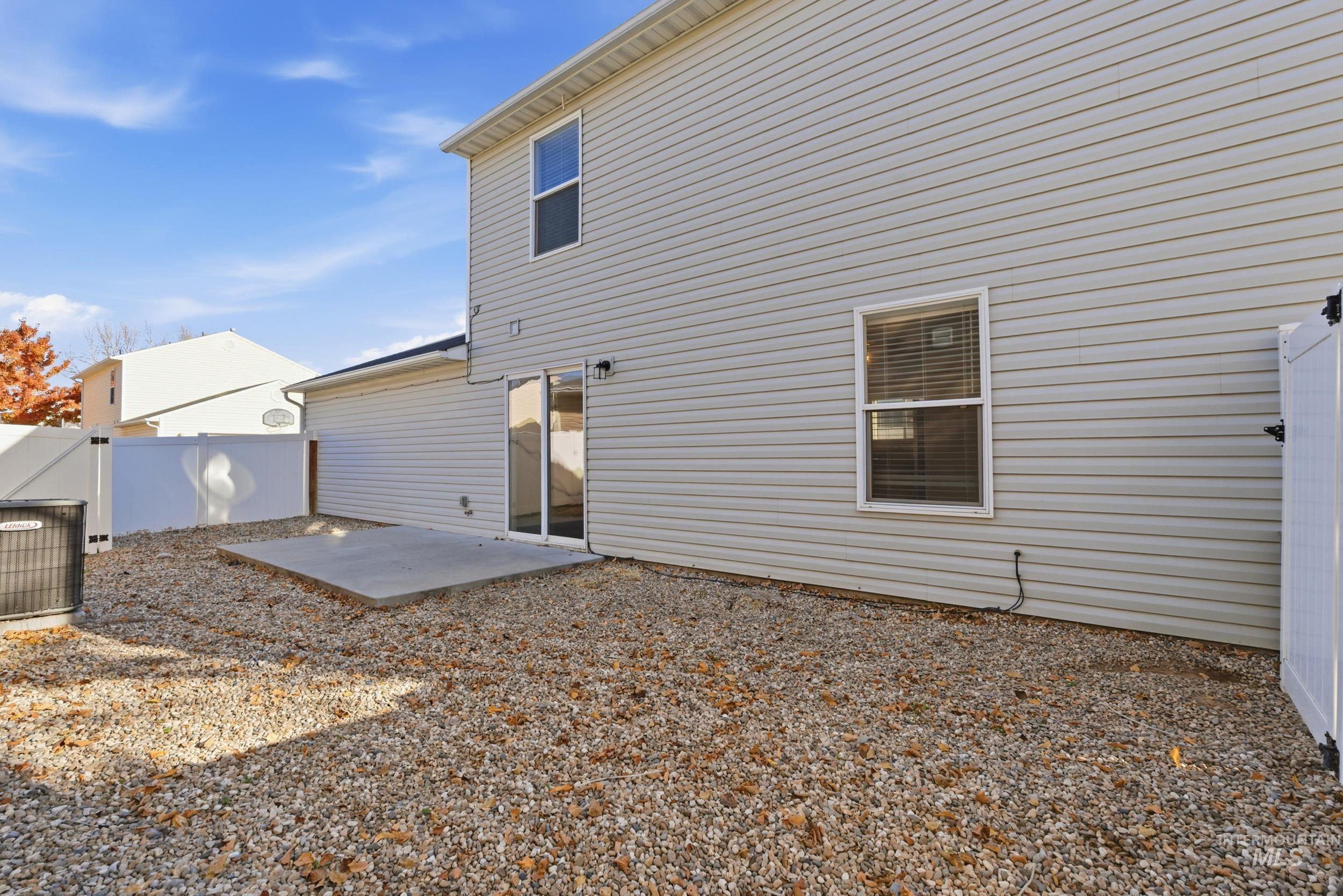 Rear view of house featuring a patio area and a fenced backyard
