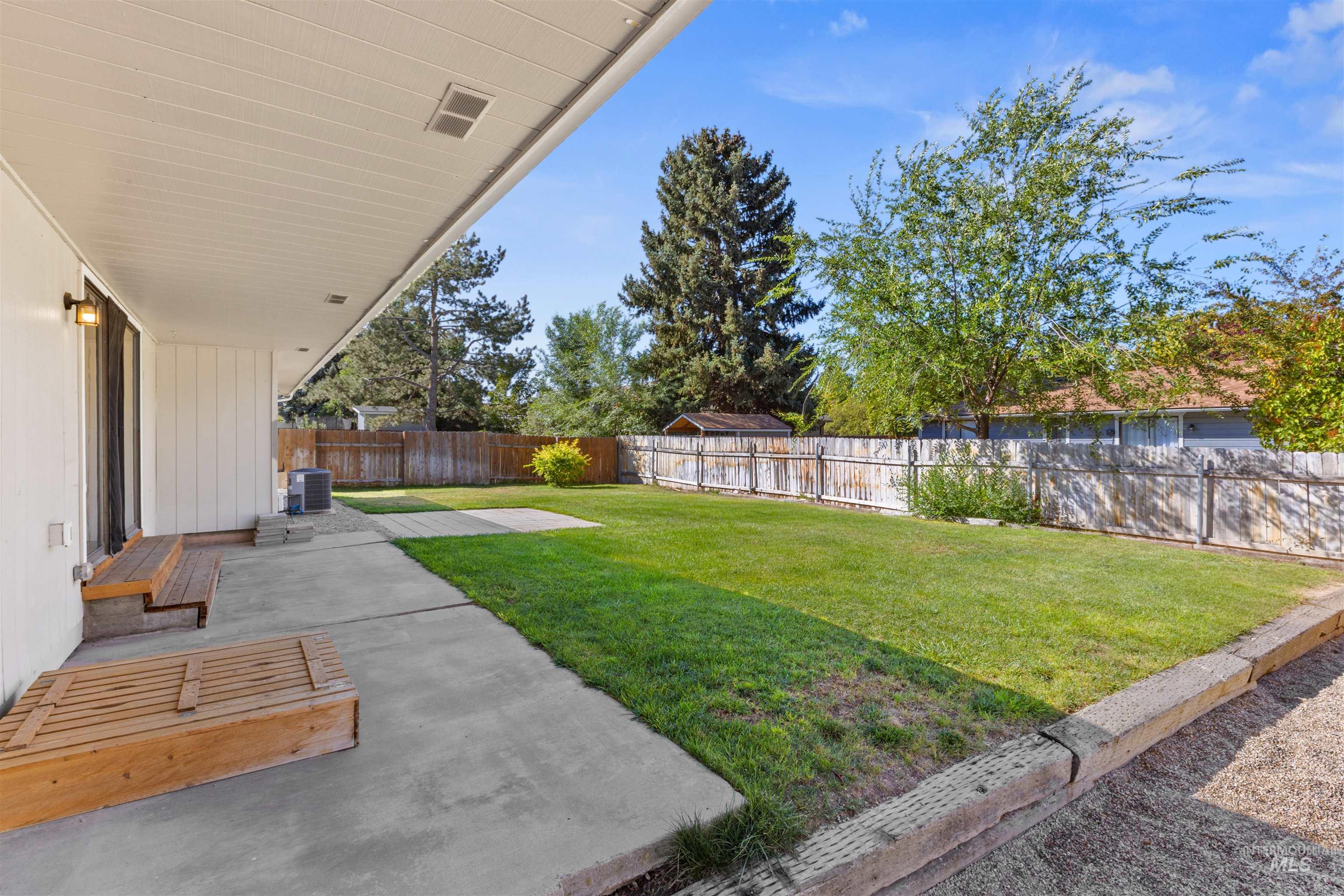 Fenced backyard featuring a patio