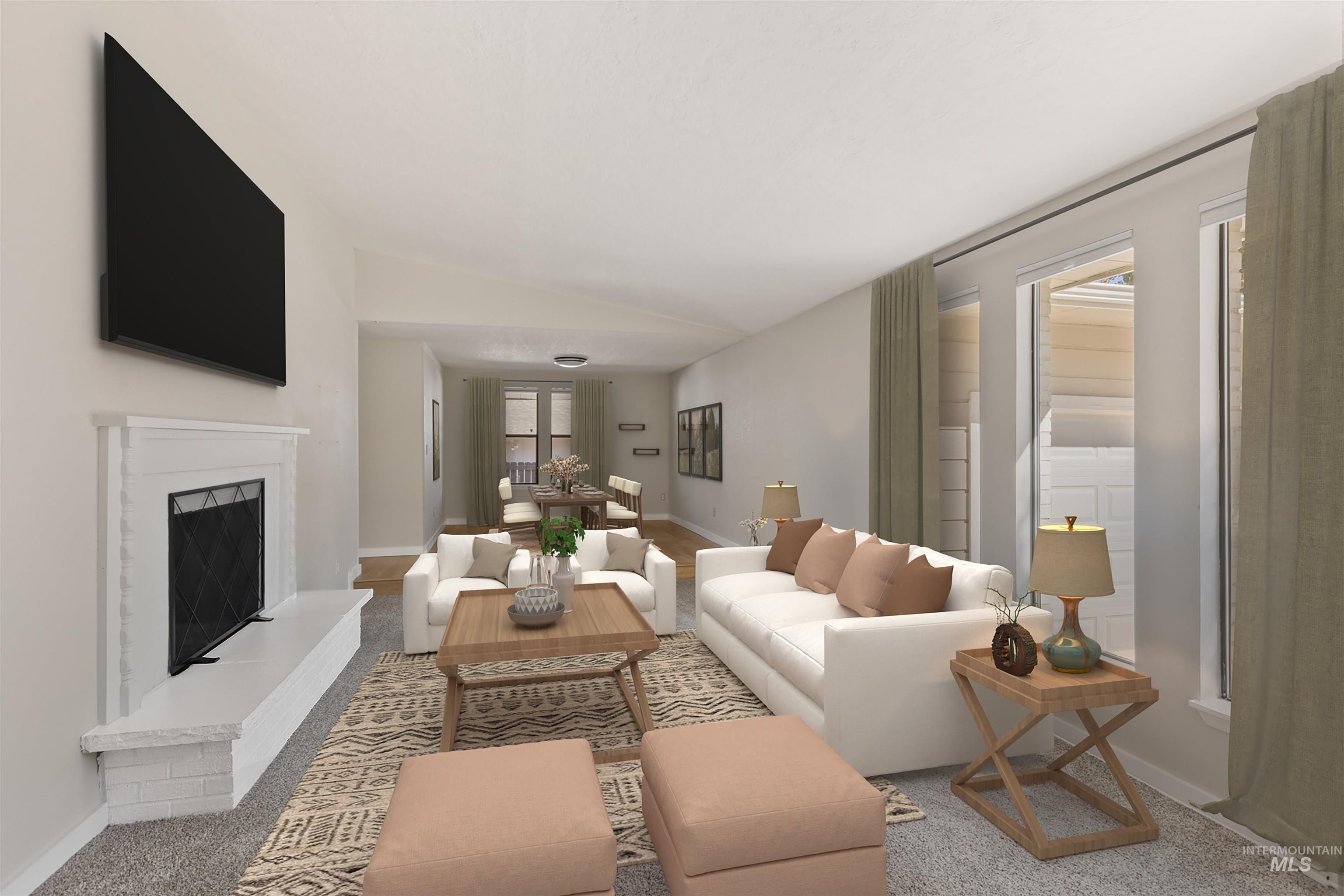 Carpeted living area featuring a fireplace and lofted ceiling
