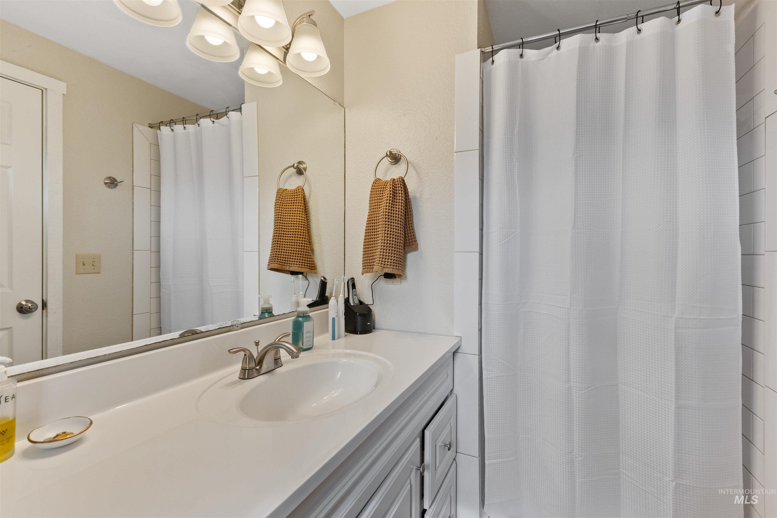 Bathroom featuring vanity and a shower with shower curtain