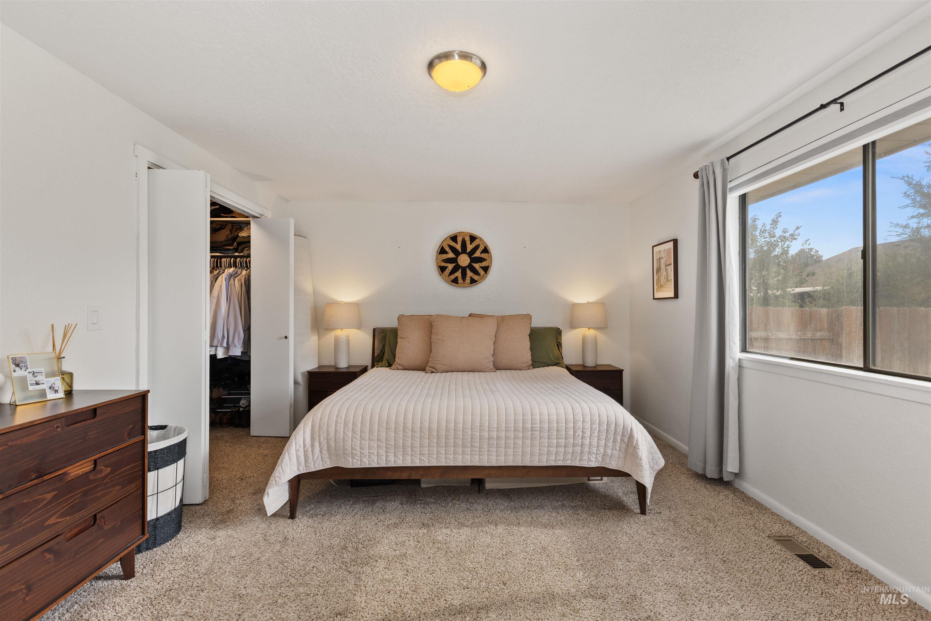 Bedroom with carpet floors and a walk in closet