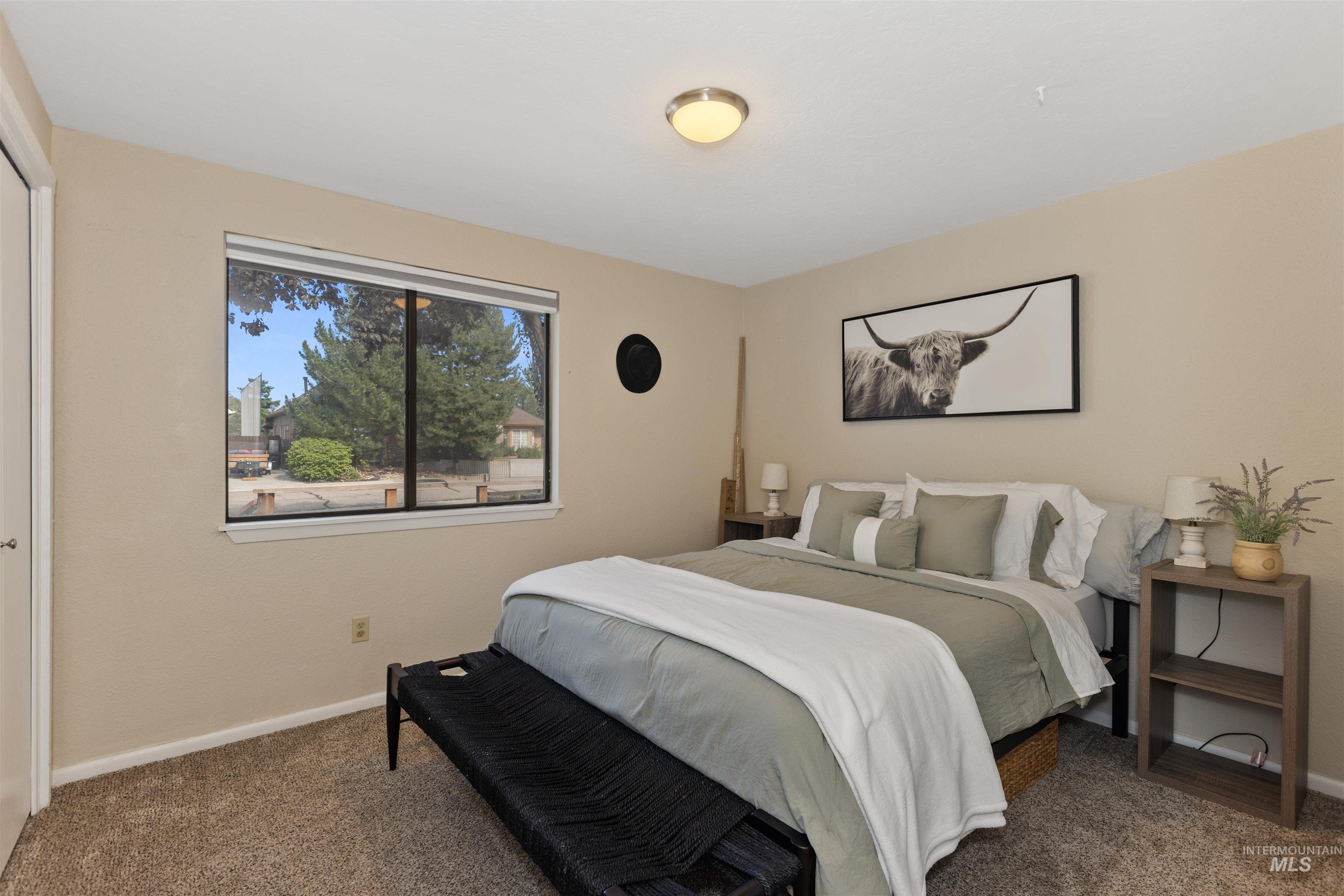 Bedroom with carpet floors and baseboards