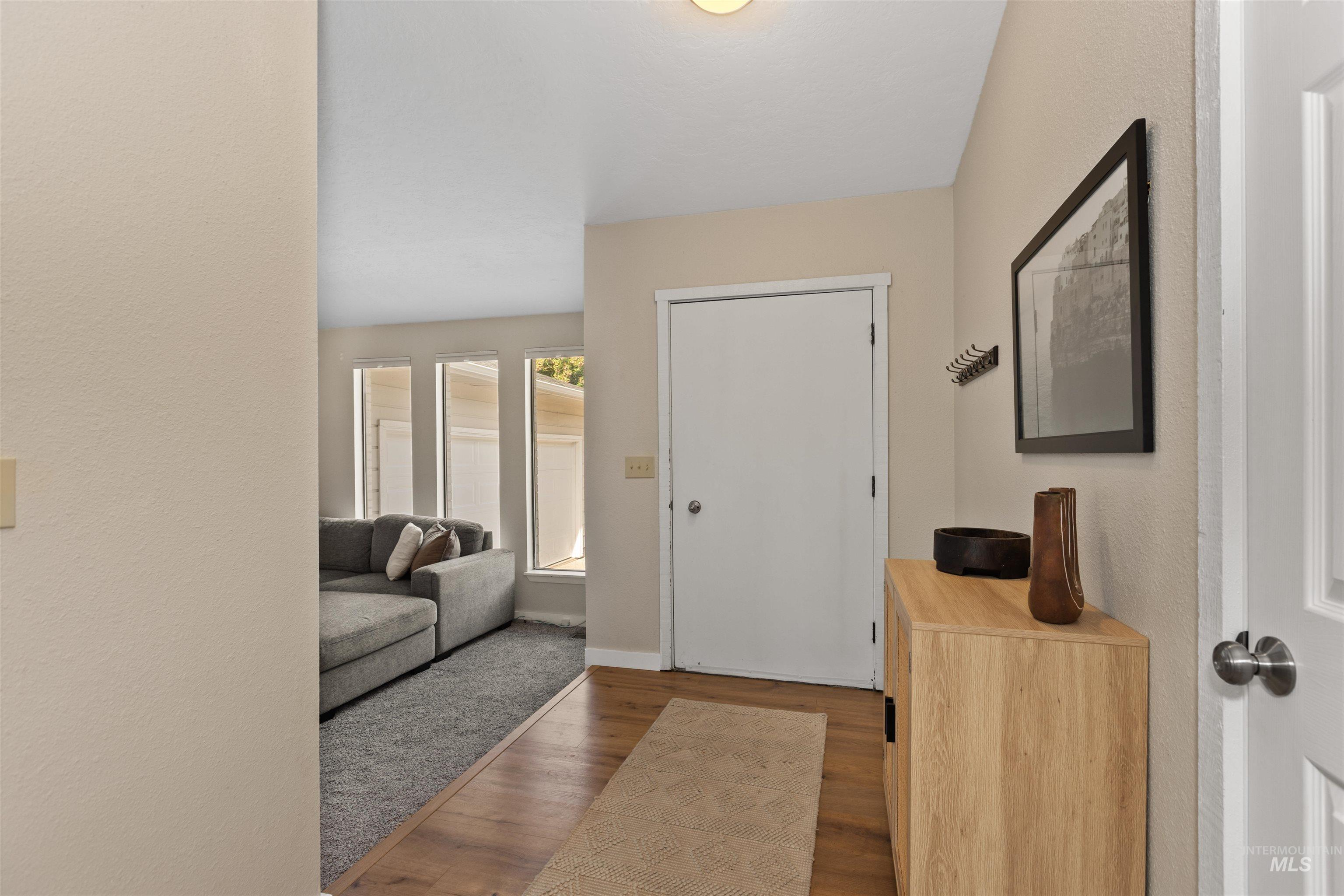 Entryway featuring wood finished floors and a textured wall