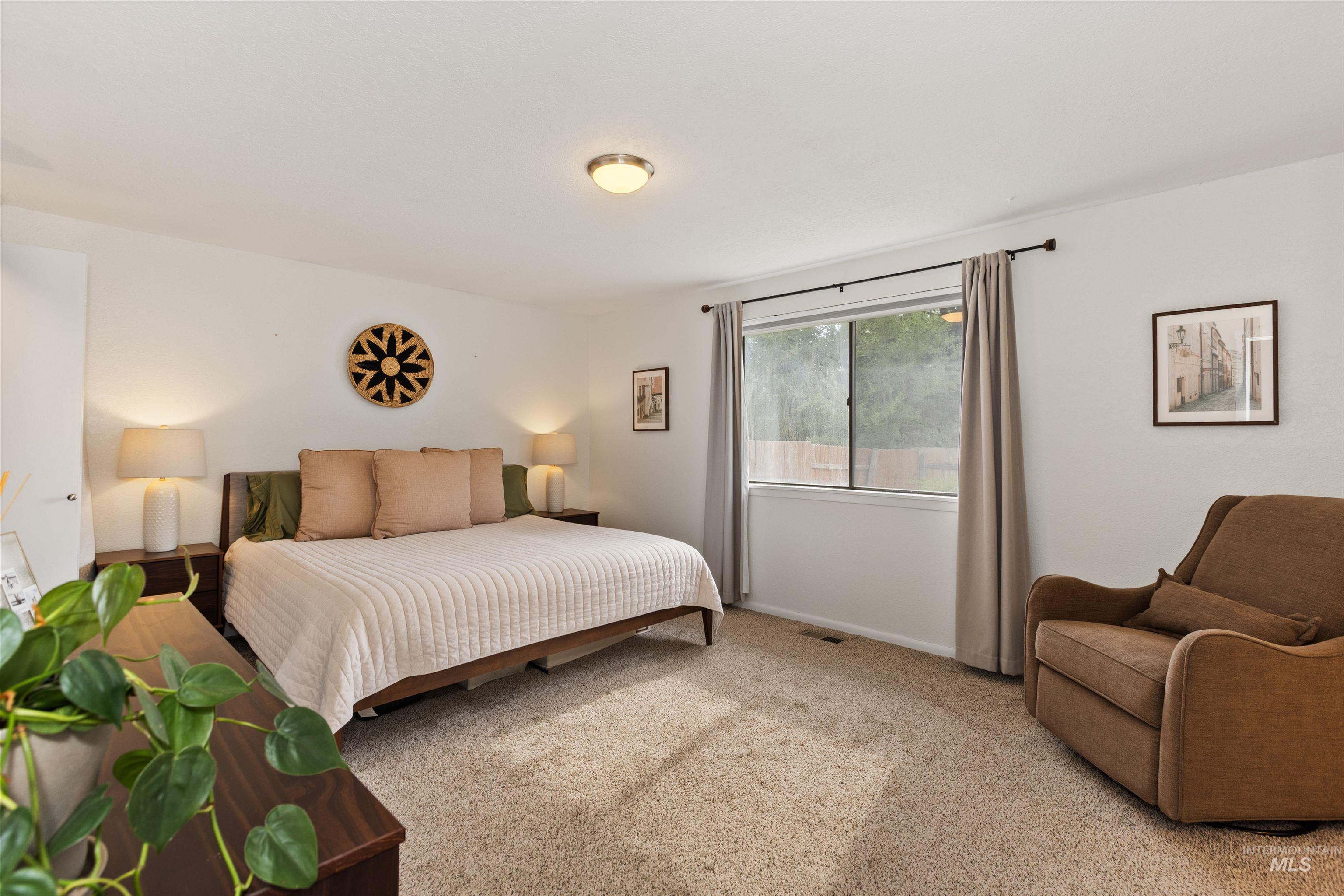 Carpeted bedroom featuring baseboards