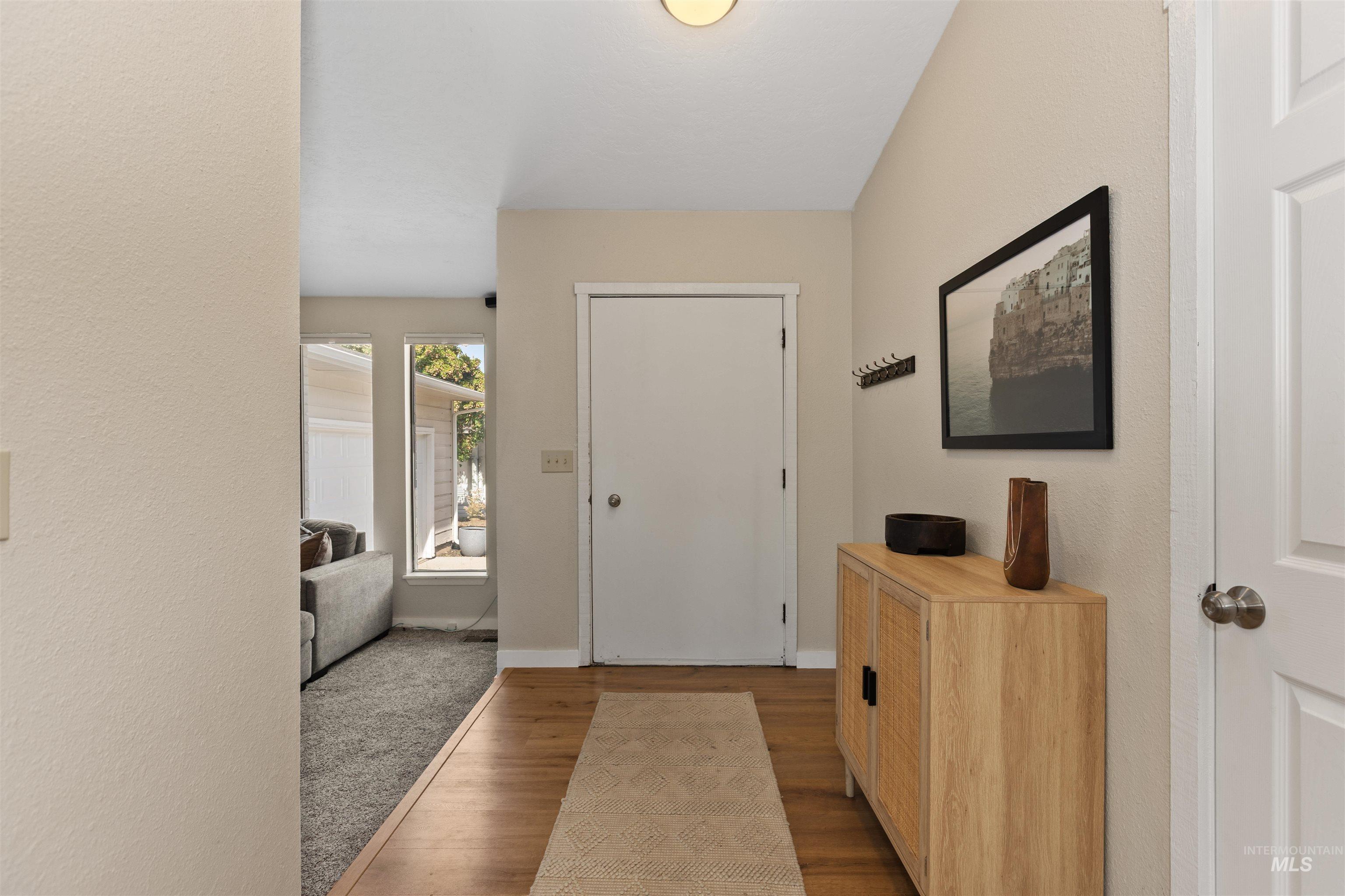 Foyer entrance featuring wood finished floors and a textured wall