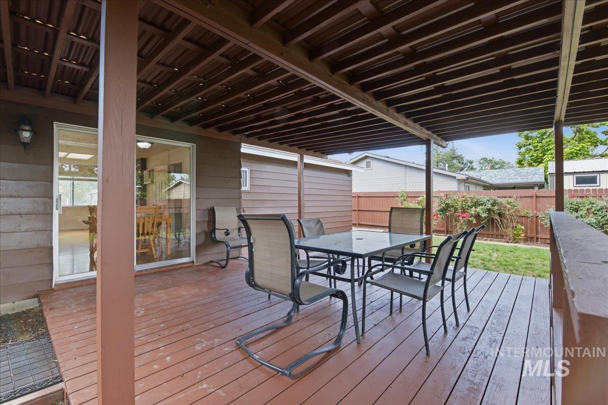 Covered wood-finish deck with a patio cover
