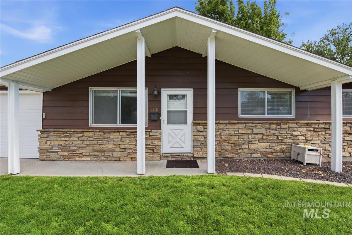Mid-century modern exterior featuring brown siding and a stacked stone facade
