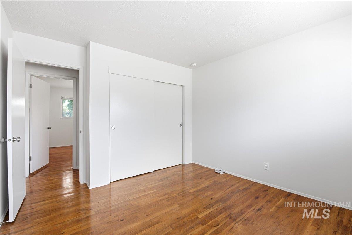 Bright interior space featuring wood-finish flooring, white walls, and a white ceiling