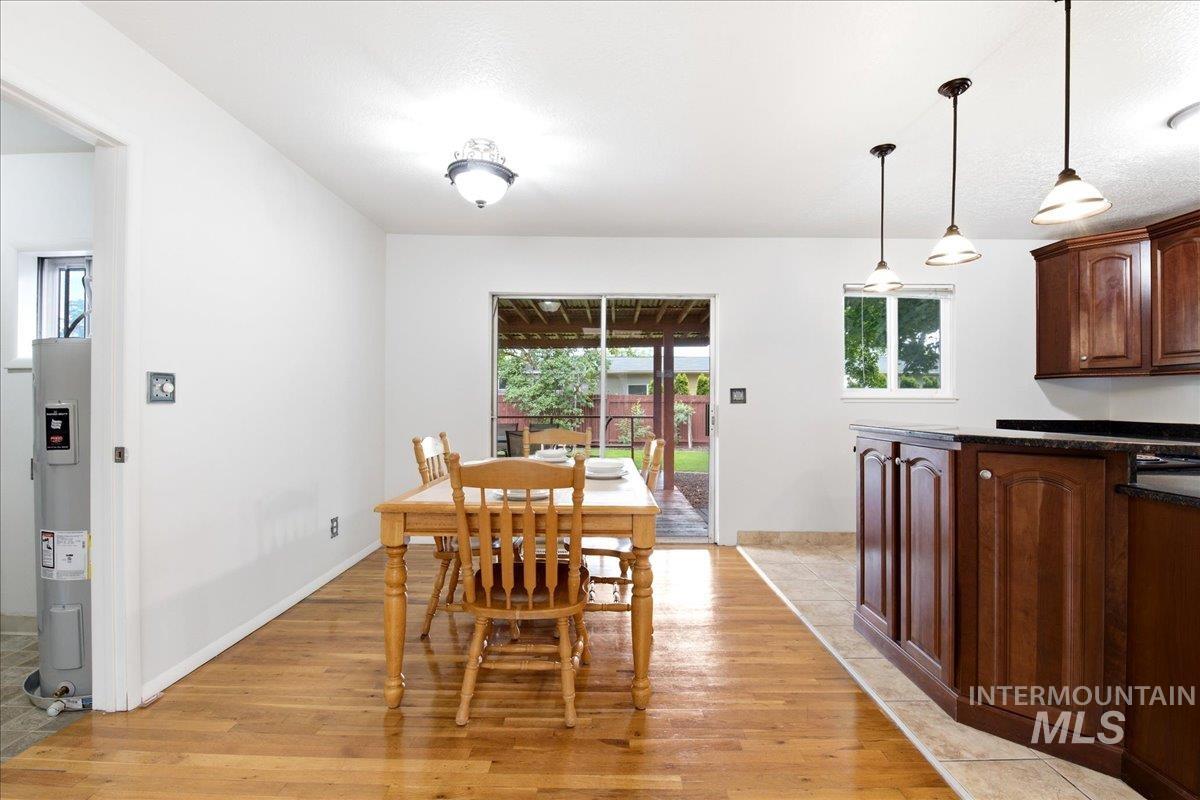 Dining area with wood-finish flooring and a sliding glass door opening to the patio