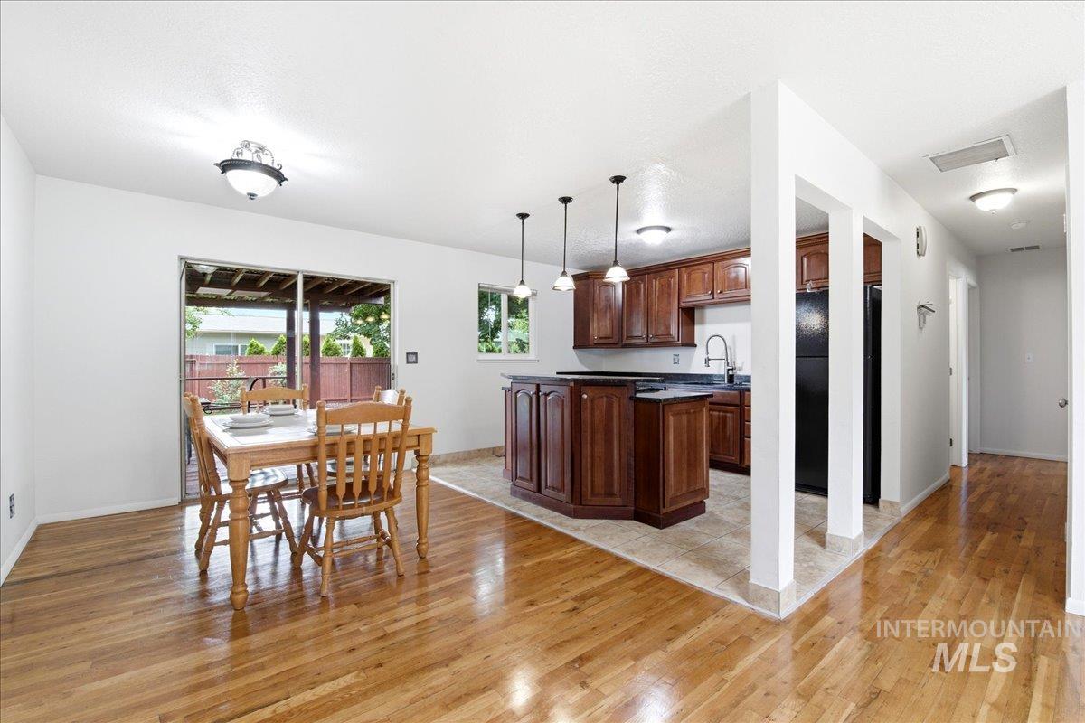 Hardwood flooring extends throughout the dining area