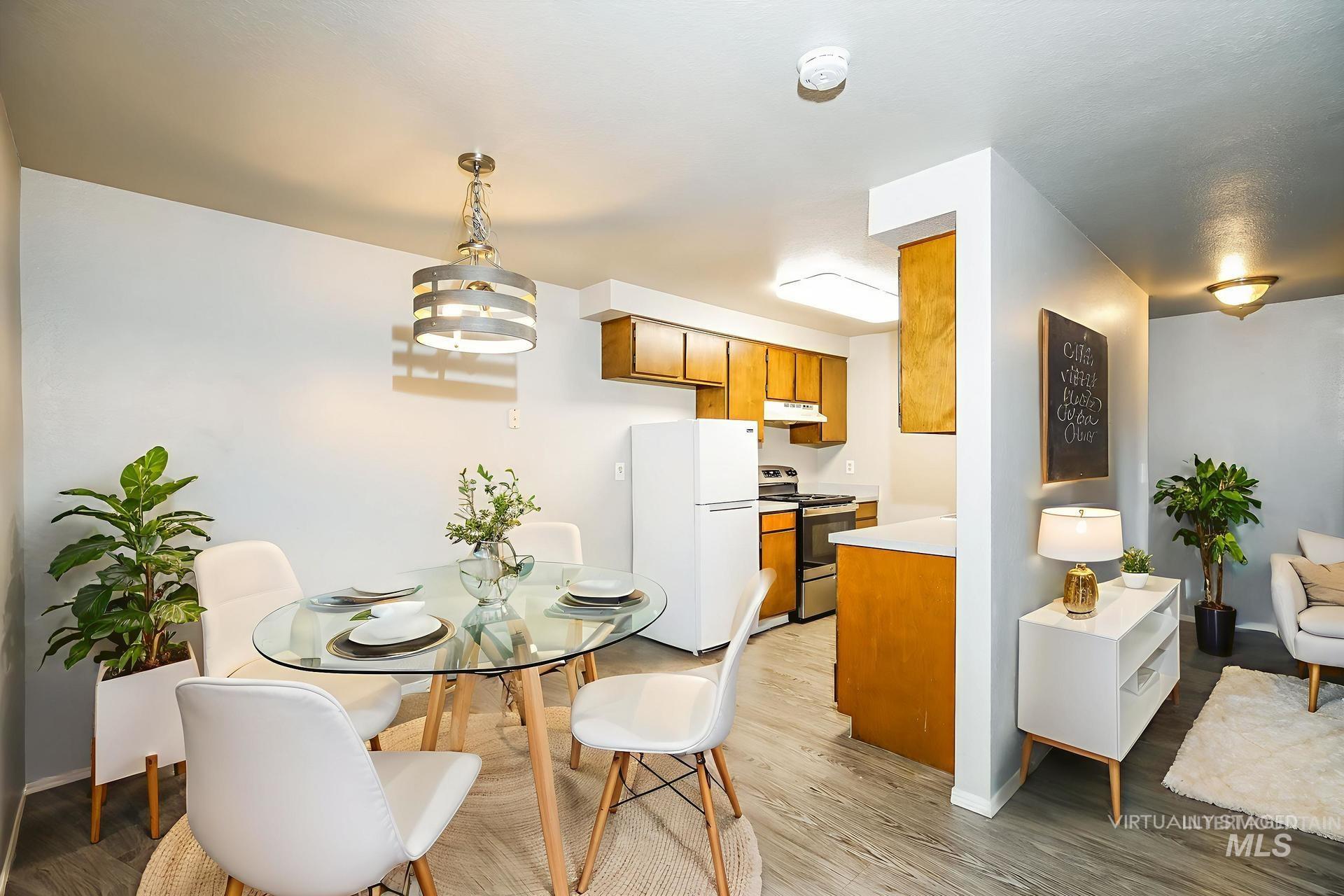 Dining room featuring light wood-style flooring and a chandelier