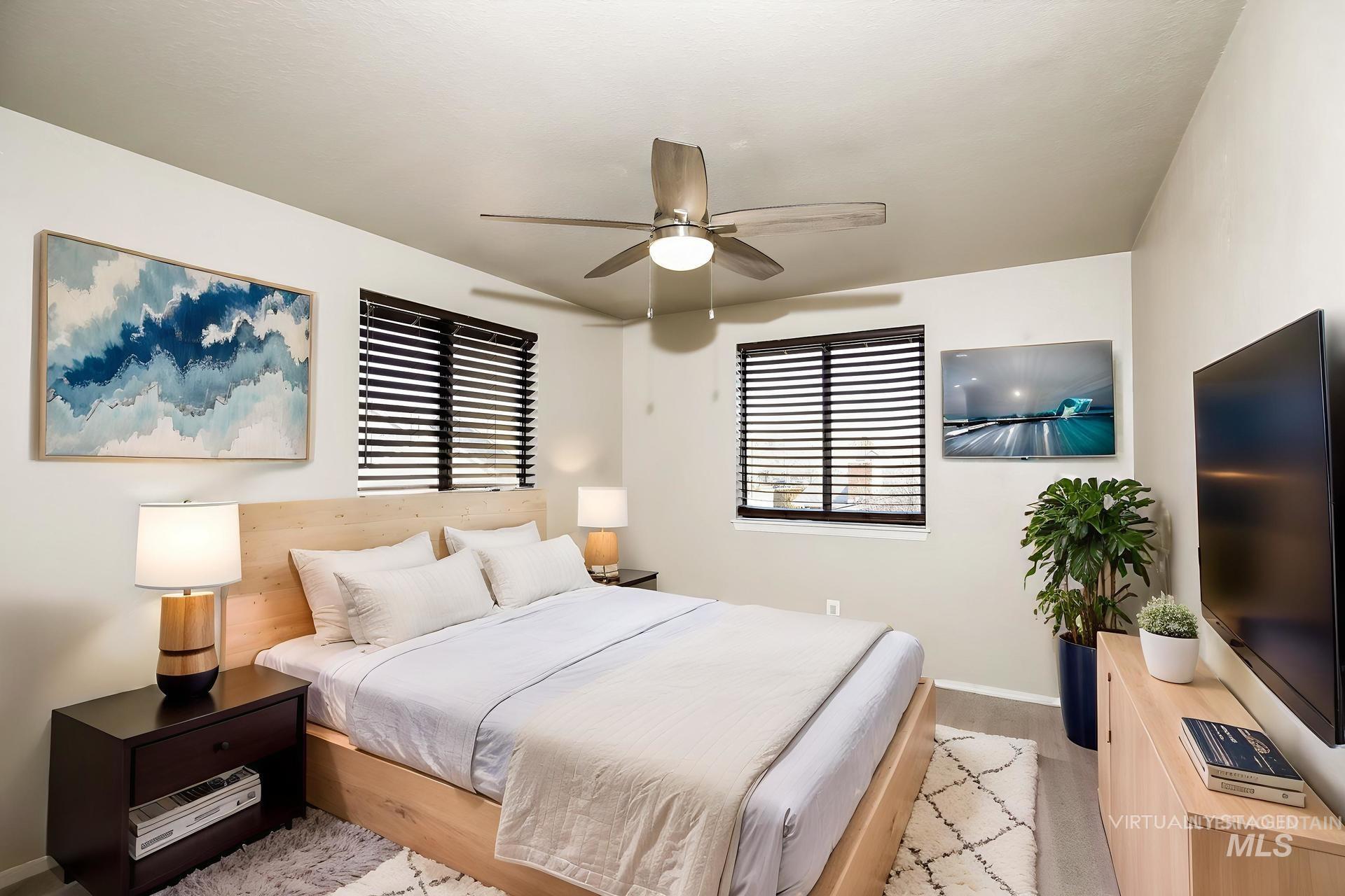 Bedroom featuring a ceiling fan and light wood-style flooring