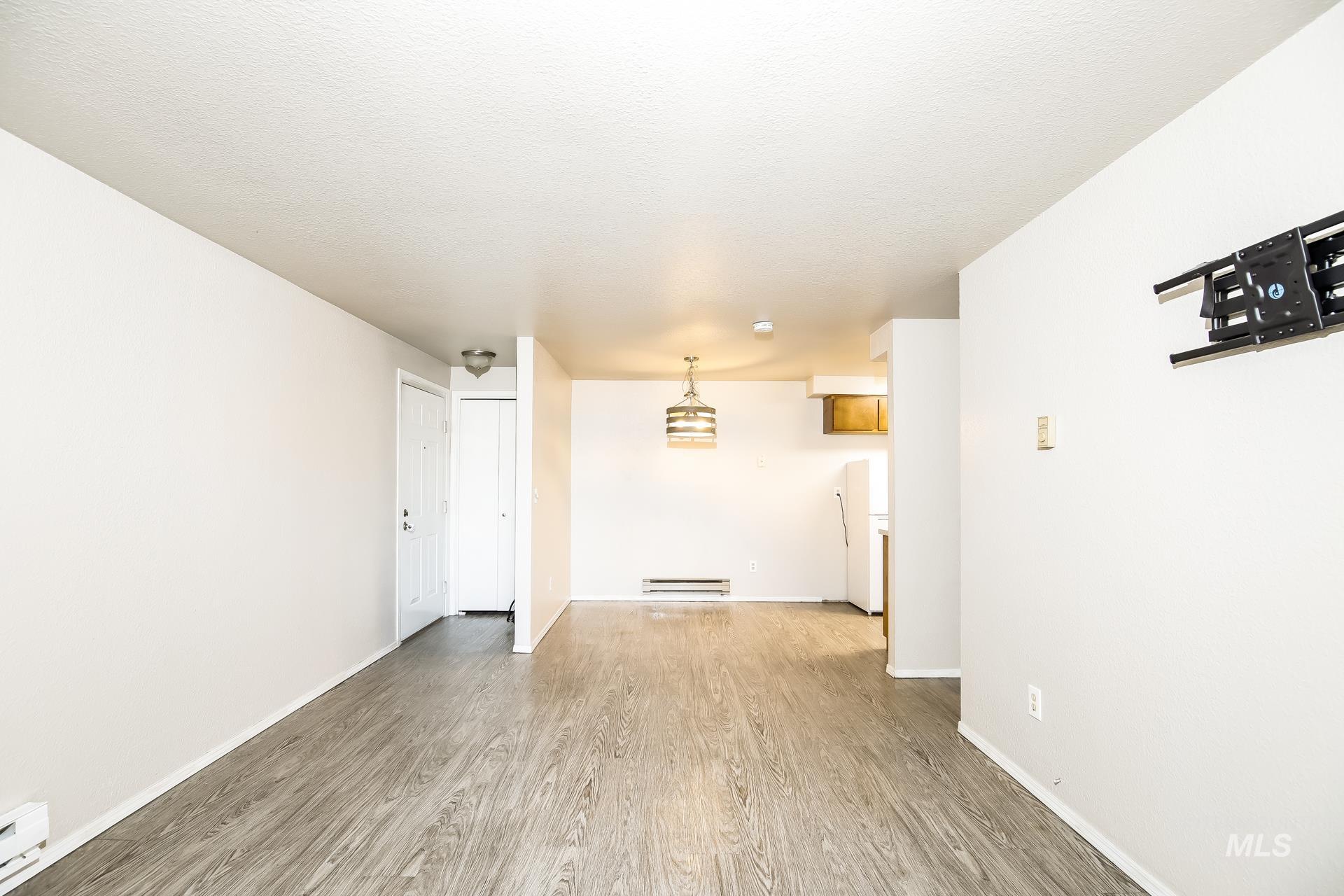 Spare room with light wood finished floors and baseboard heating