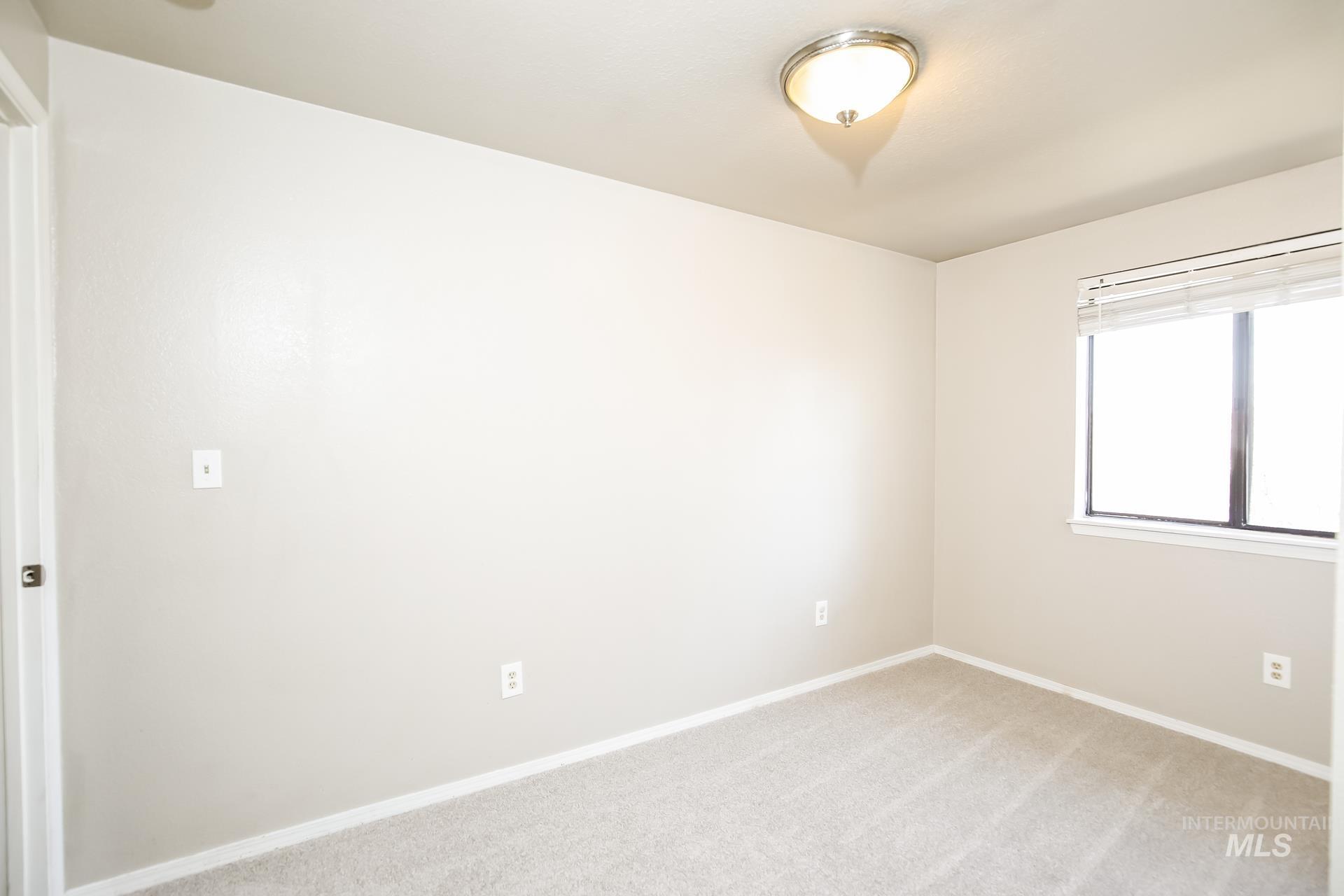 Empty room with baseboards and carpet flooring