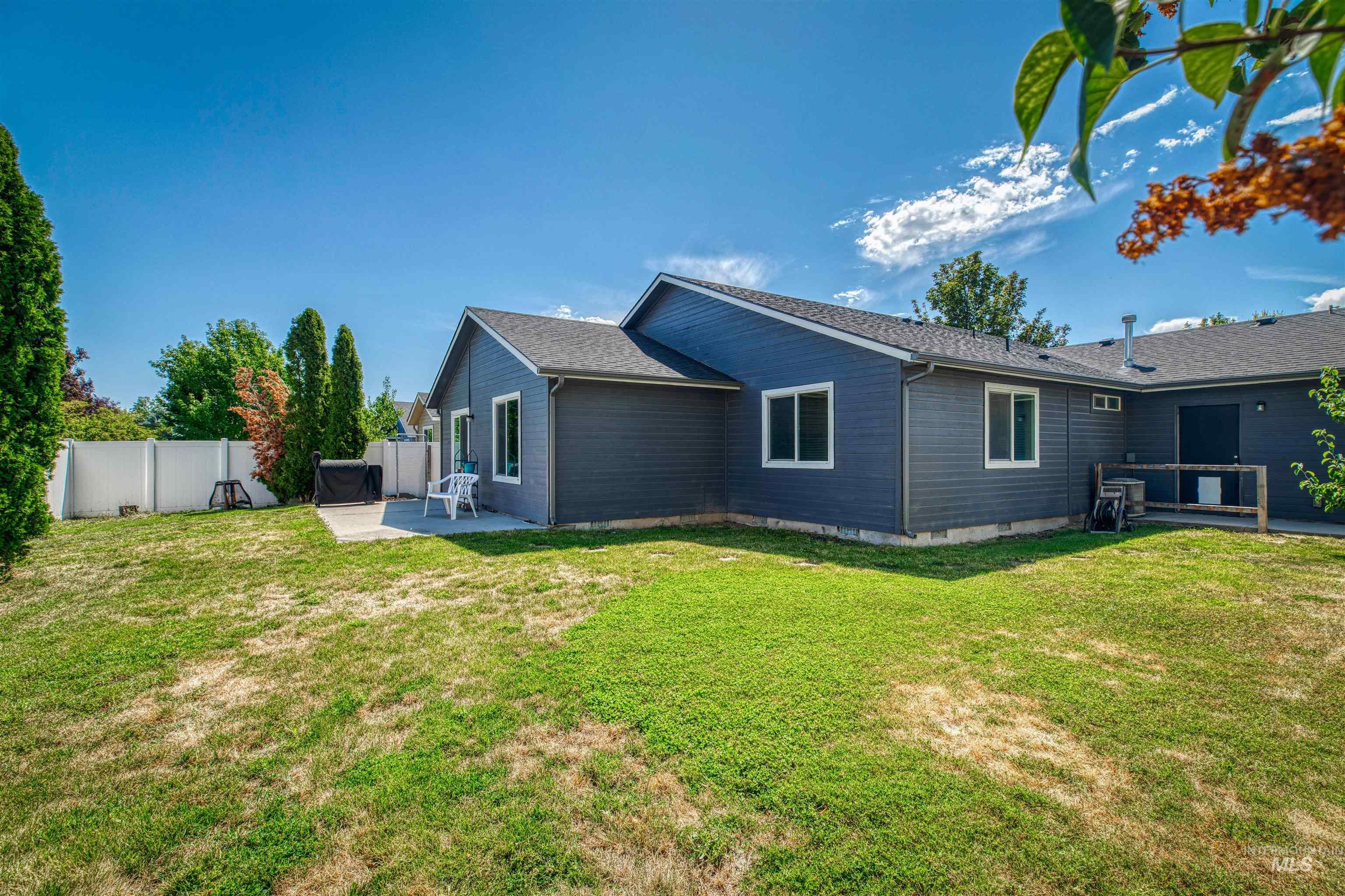Back of house featuring a patio area, a shingled roof, and crawl space