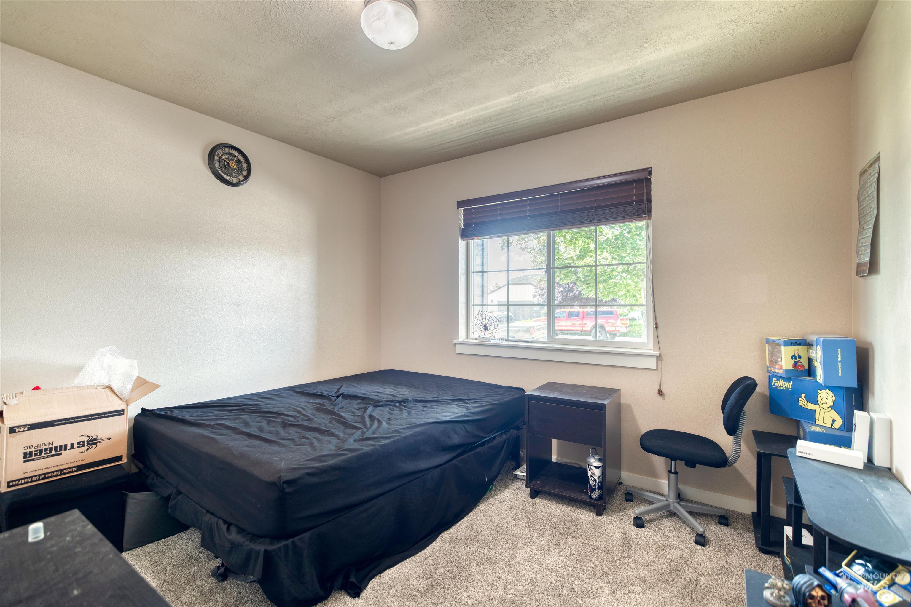 Bedroom featuring carpet floors, pool table, and a textured ceiling