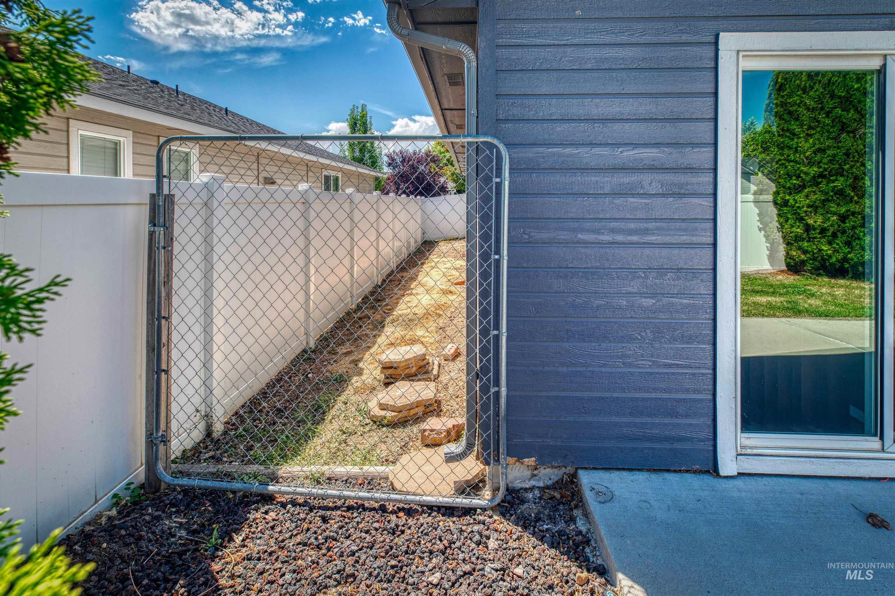 View of side of property featuring a gate