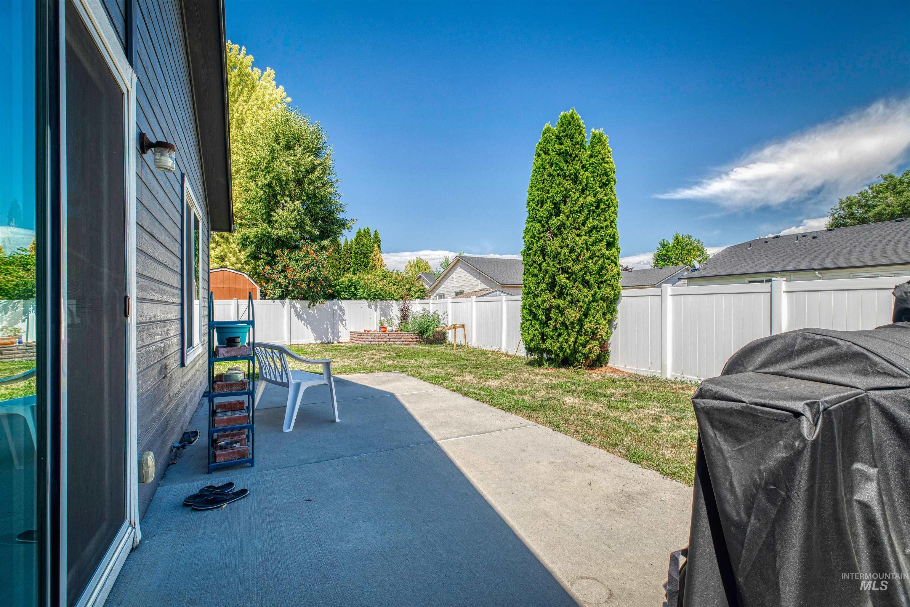 Fenced backyard featuring a patio