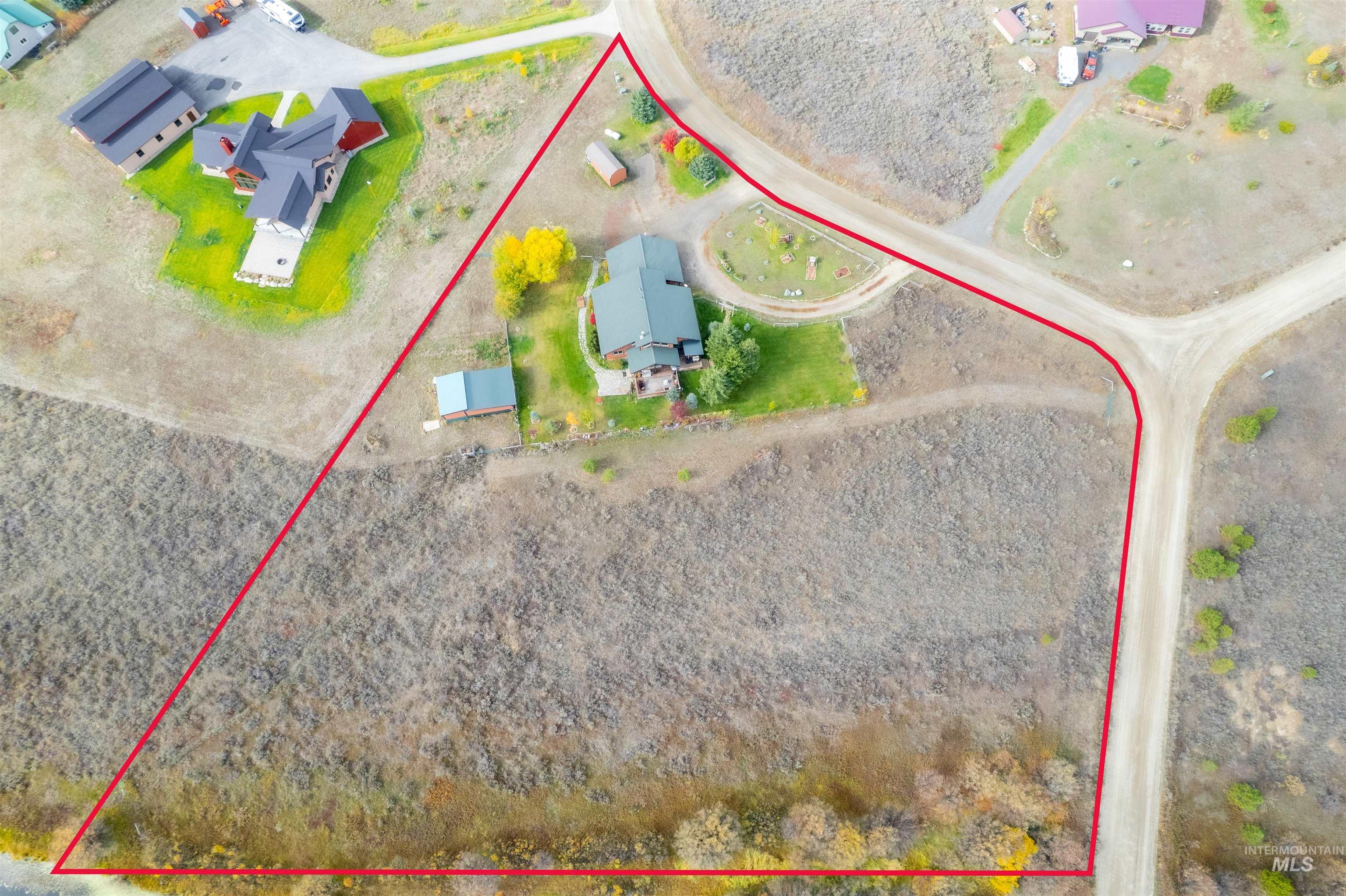 Aerial view of property and surrounding area with property boundaries highlighted