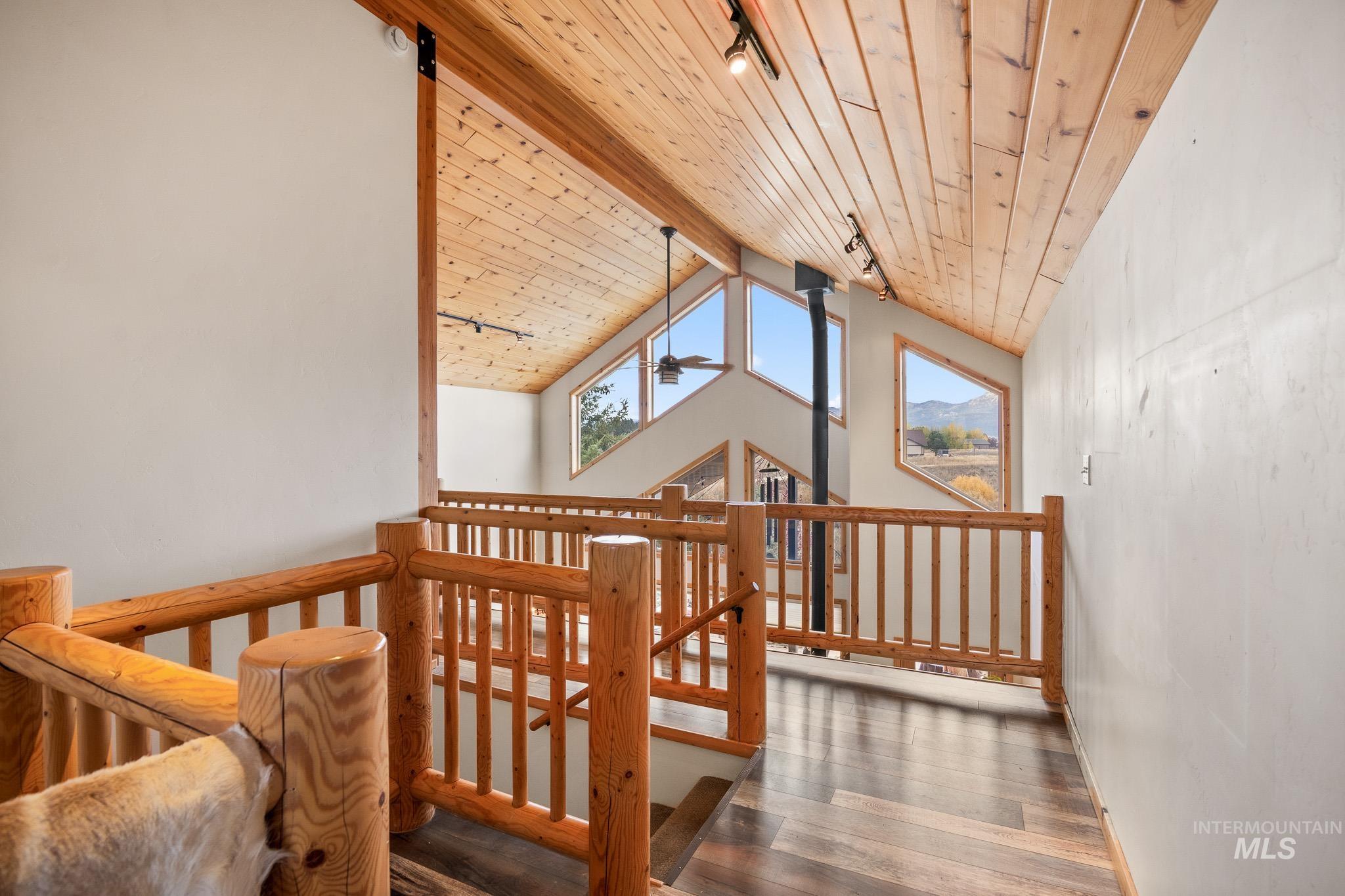 Additional living space featuring wooden ceiling, dark wood-type flooring, and ceiling fan