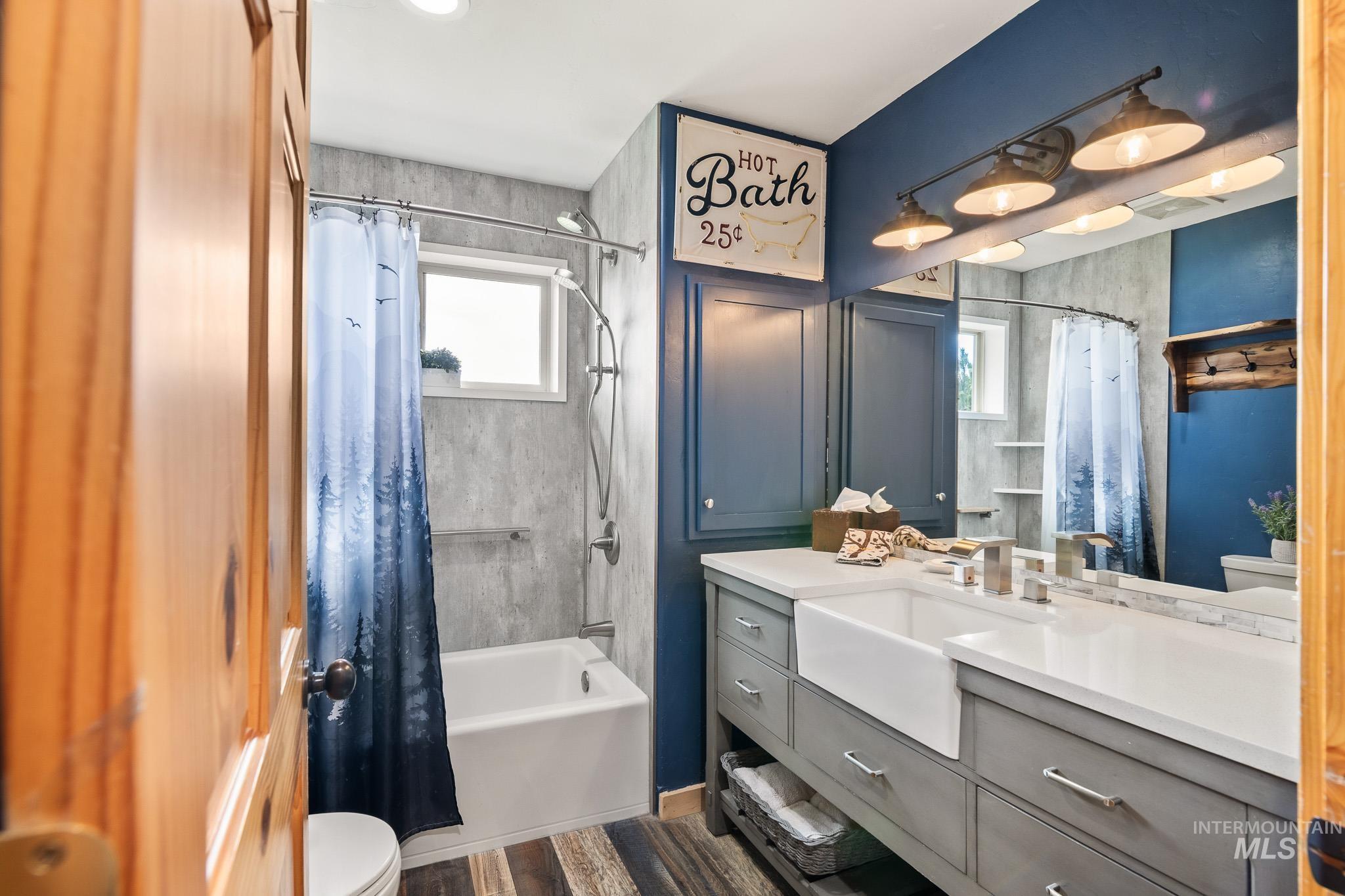Bathroom featuring shower / tub combo with curtain andvanity