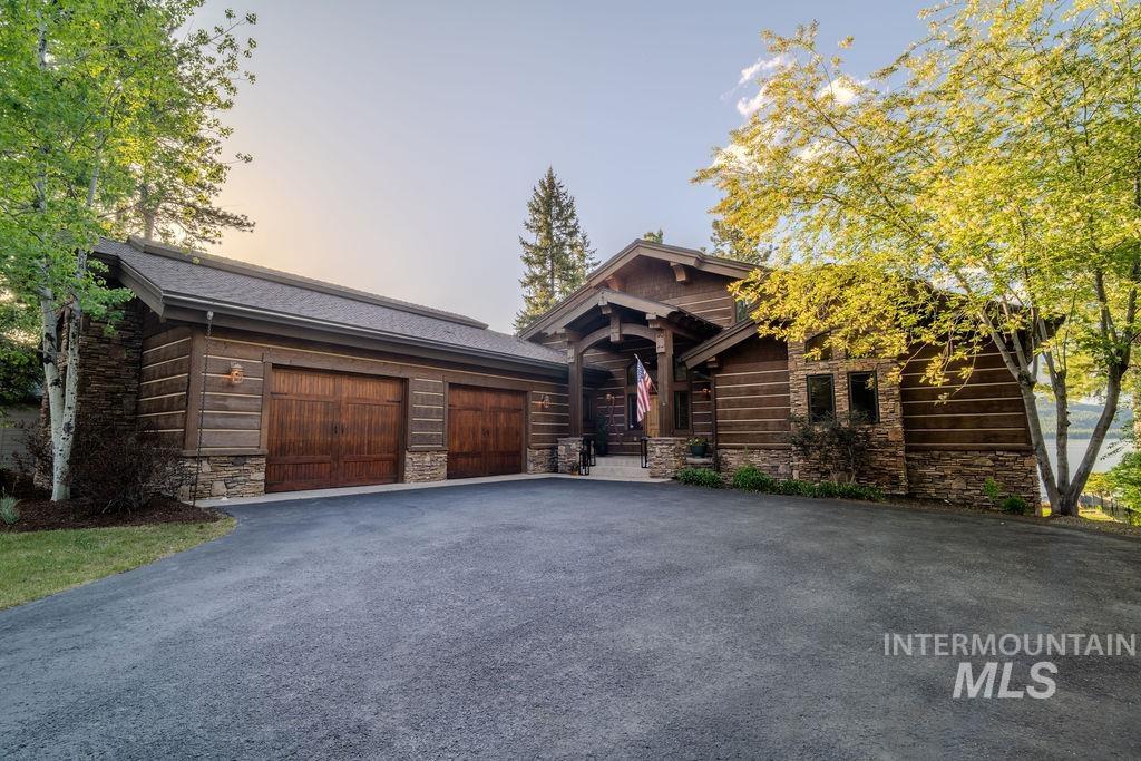 Rustic exterior featuring dark wood siding, stone accents, and a covered entry