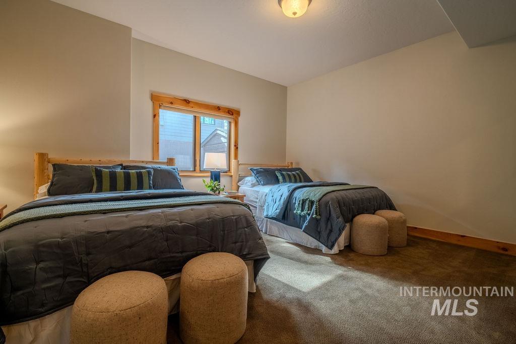 Carpeted bedroom with a natural wood-trimmed window