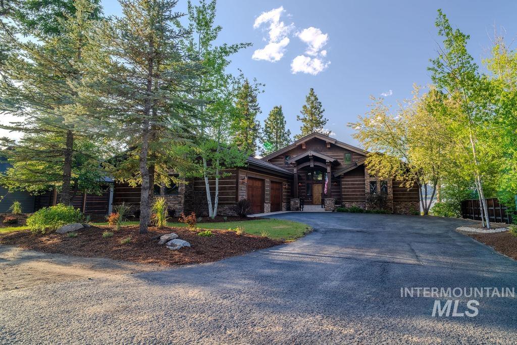 Rustic wood-sided exterior with stone accents and a covered front entry