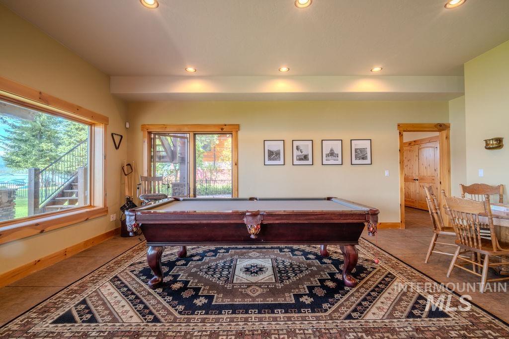 Recreation area featuring recessed lighting, a large picture window, and sliding glass doors with wood trim