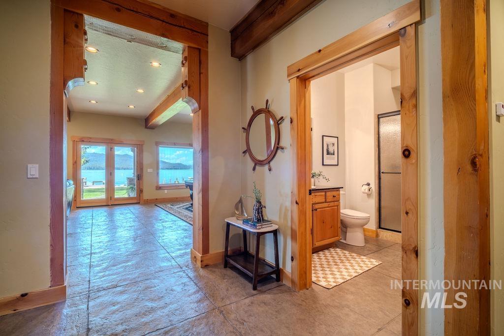 Interior featuring visible structural timber framing and stamped concrete flooring